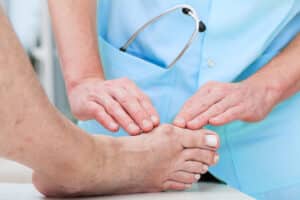 A doctor evaluating a patient’s bunion before a bunionectomy