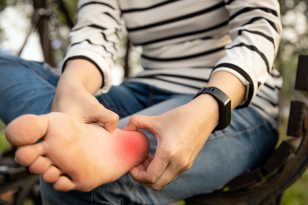 Woman experiencing pain from flat feet in Prescott, AZ
